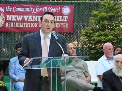 A speaker addressing the audience during a celebration event