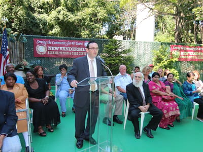 Outdoor event with speakers and attendees at a celebration