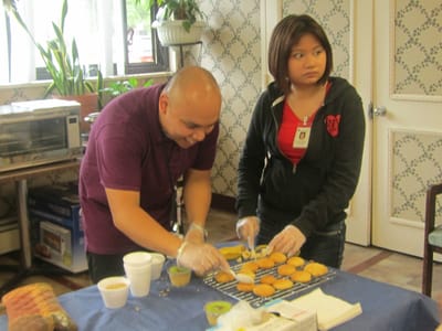 Staff and resident preparing cookies in the activity room