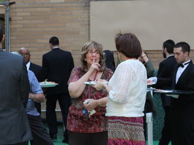 Guests enjoying a social event with food outdoors