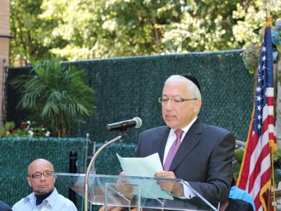 A speaker addressing an audience at an outdoor event
