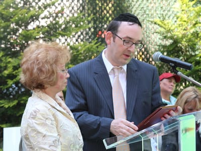 Two people speaking at an outdoor event