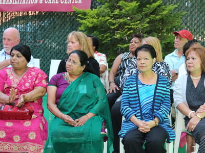 Residents attending an outdoor gathering at the facility