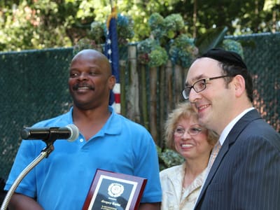Residents and staff at an award celebration outdoors