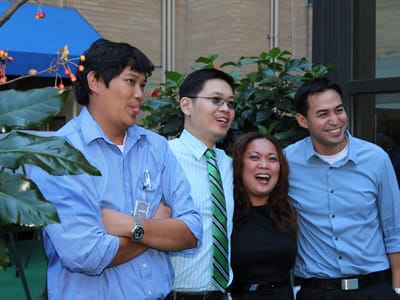 Staff members posing together in a garden area