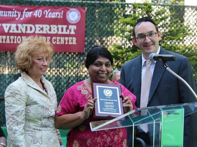 Celebration event with staff presenting an award
