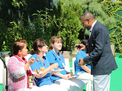 Residents and staff enjoying a meal outdoors