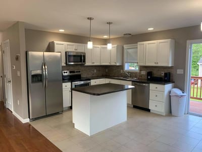 Modern kitchen with stainless steel appliances and white cabinets