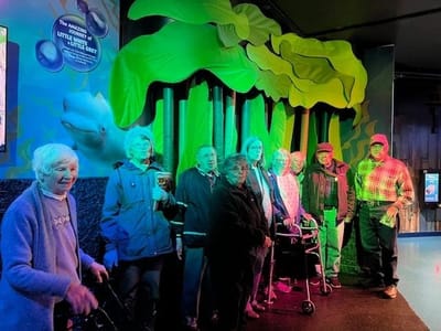Residents posing in a colorful indoor setting