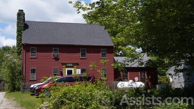 Exterior view of a red building surrounded by greenery