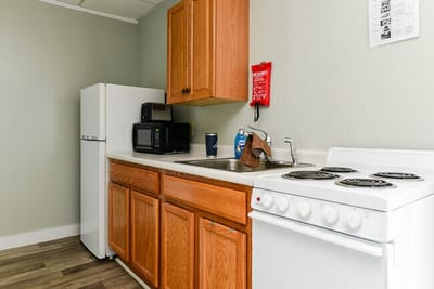 Kitchen with appliances and cabinetry in a resident unit
