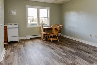 A simple dining area with a table and chairs