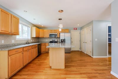 Bright kitchen area with wood cabinetry