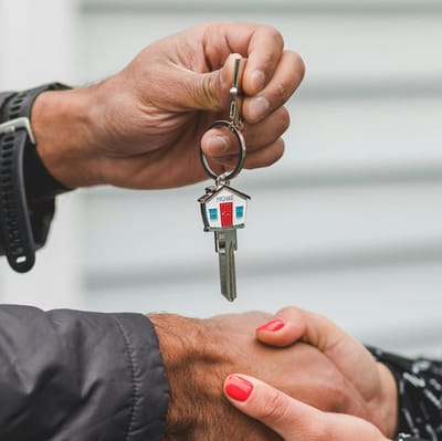Close-up of hands holding a house key.