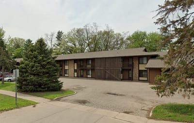 Exterior view of a residential building with trees.