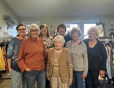Group of residents smiling in a common area.