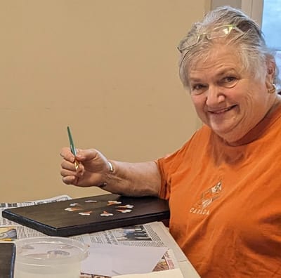 Resident painting during an activity session.