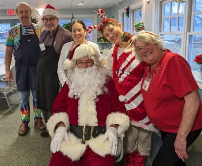 Staff and residents celebrating with festive attire.