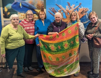 Residents enjoying a group activity with a colorful fabric