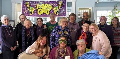 Residents celebrating Mardi Gras in a festive setting.