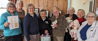 Residents and staff celebrate with stuffed animals.