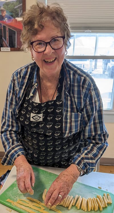 Resident enjoying a baking activity in the kitchen.