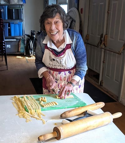 Senior resident making pasta in the kitchen.