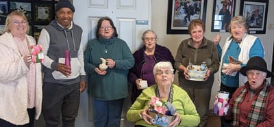 Residents holding crafts together in a common area