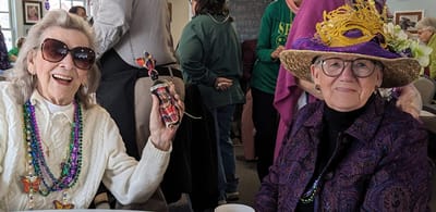 Two smiling seniors enjoying a celebration.