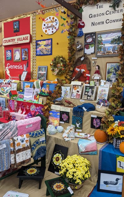 Displays handmade crafts and decorations at a community event.