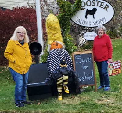 Two women with a Halloween-themed decoration.