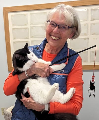 Resident enjoying time with a cat indoors.