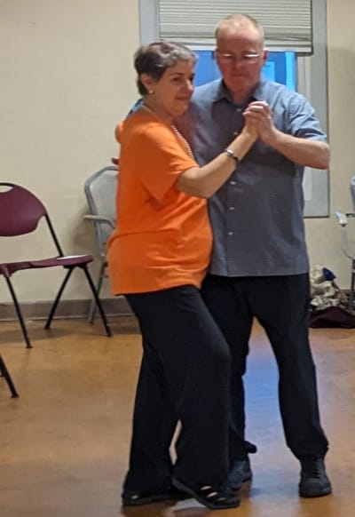 Residents dancing together in a common area.