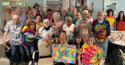Residents celebrating with colorful tie-dye shirts.