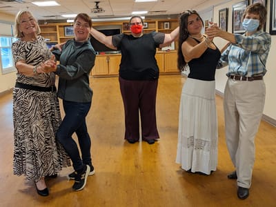 Residents and staff dancing in a common area