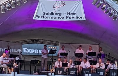 Band performing at an outdoor event stage.
