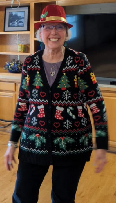 Resident joyfully celebrating in festive attire.