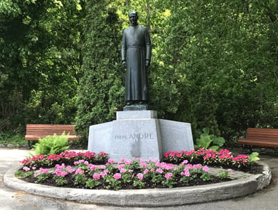 Statue surrounded by flowers in outdoor area