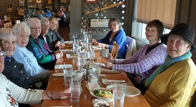 Group of seniors enjoying a meal together.