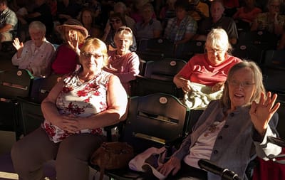 Group of residents enjoying a performance together