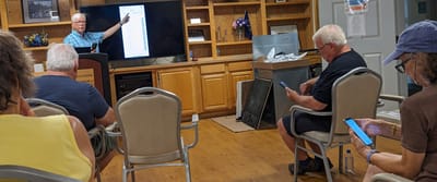 Residents engaged in a discussion during a presentation.