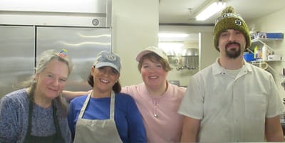 Staff members smiling in the kitchen
