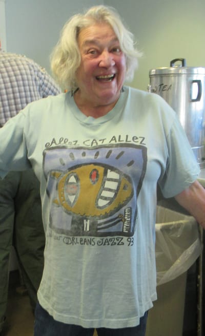 Resident smiling in a colorful shirt indoors.
