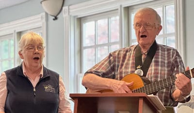 Two residents singing with a guitar