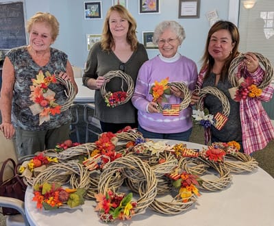Residents participating in a fall wreath-making activity.