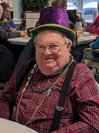 Senior resident celebrating in festive attire.