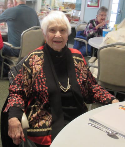 Senior resident enjoying time in a common area.