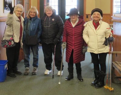 Residents smiling together in a common area.