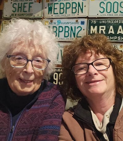 Two women smiling in a cozy setting