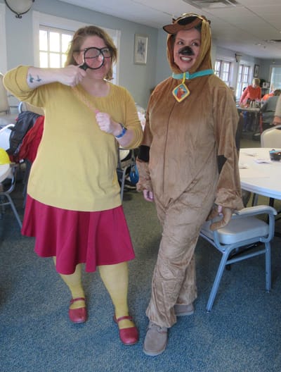 Staff in costumes celebrating an event indoors